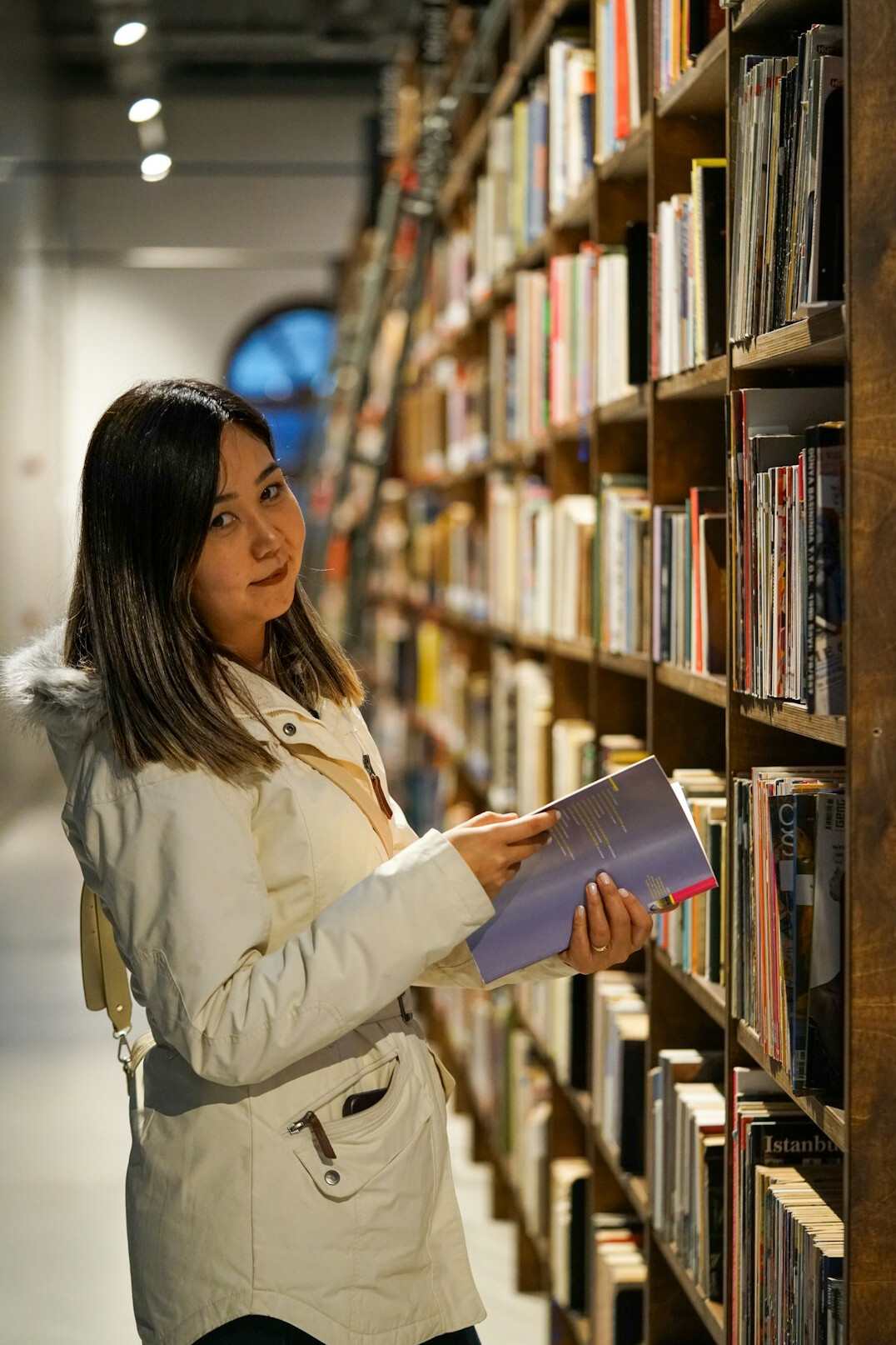 person reading book in library