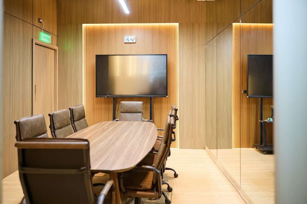 Bright minimalist meeting room with a long table and chairs