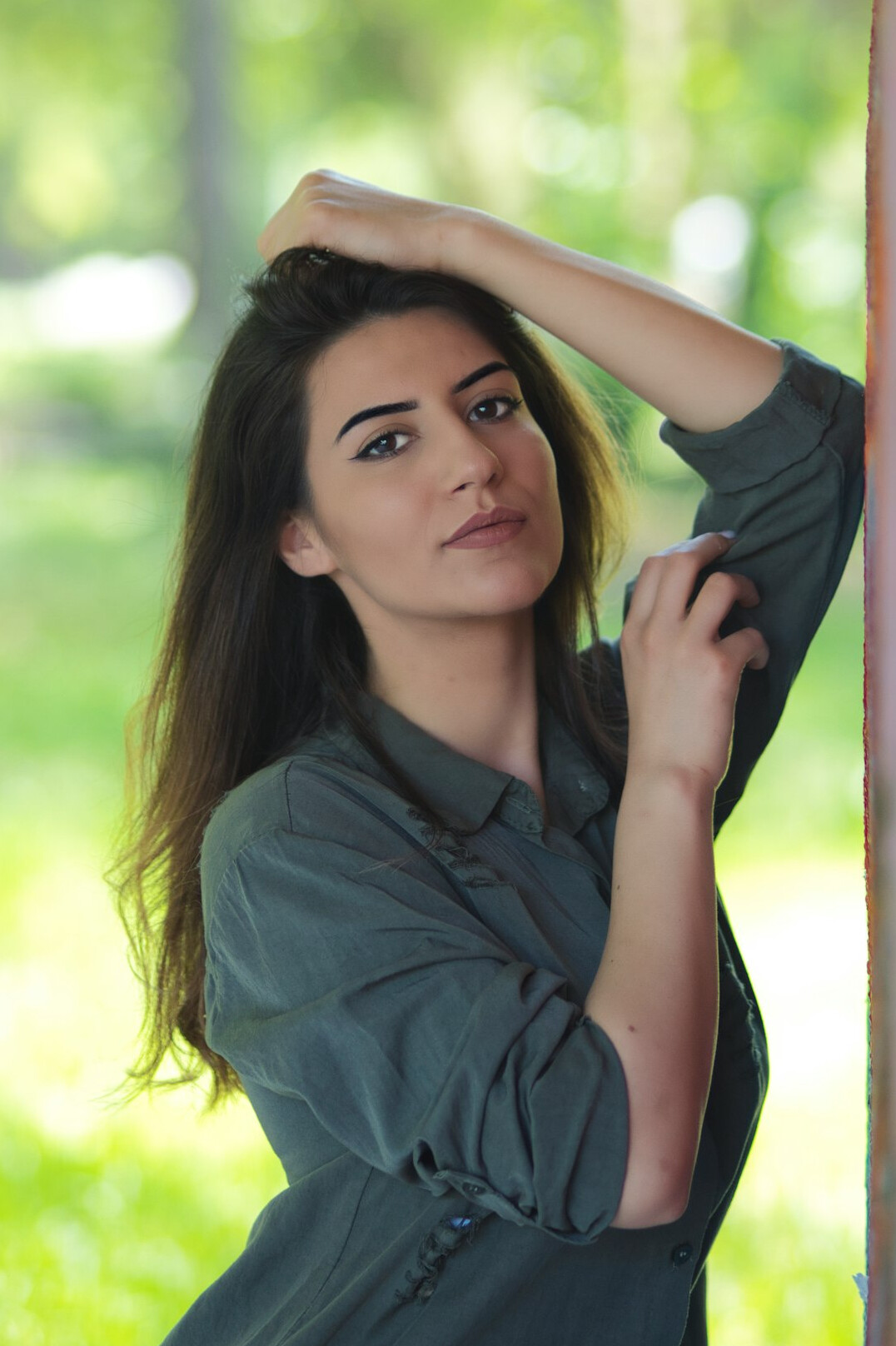 Professional portrait of a warm woman in her fifties with shoulder-length brown hair and a green blouse